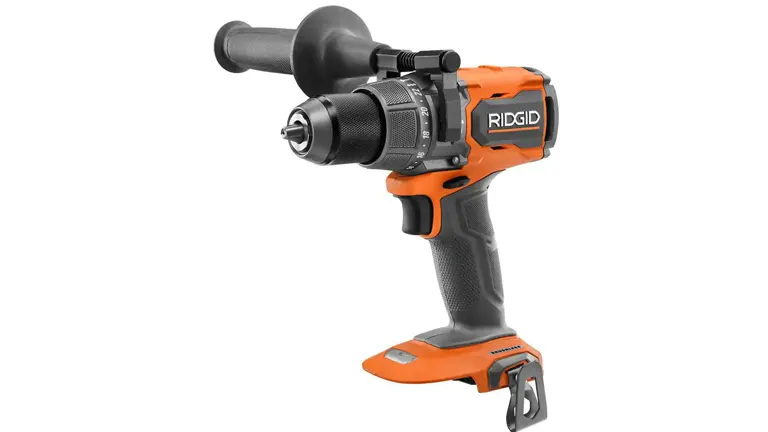 A cordless RIDGID hammer drill with an orange and black color scheme, featuring a brushless motor, a half-inch ratcheting chuck, and an auxiliary side handle.