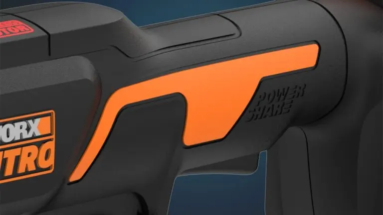 A close-up of a Worx NITRO power tool with an orange Power Share badge on its black body.
