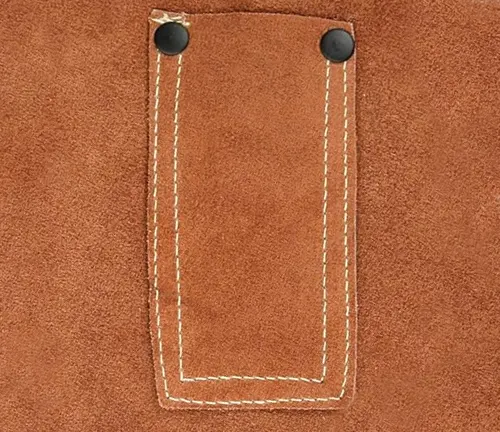 Close-up of a stitched leather pocket on a Revco Men's Split Leather Welding Jacket with black snap buttons.