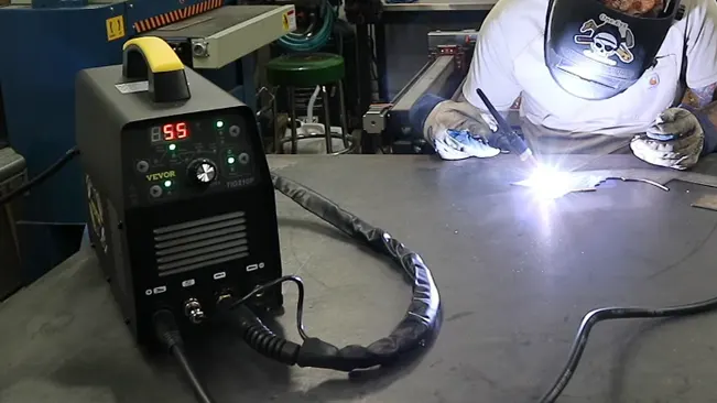 VEVOR TIG Welder 210Amp displayed on a workbench with a person welding in the background.