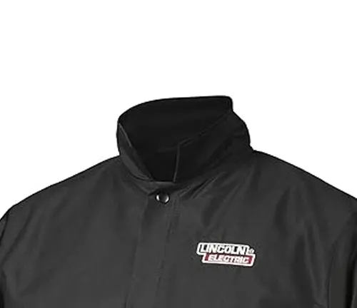 Close-up of the upper part of a Lincoln Electric K2985 black flame-resistant welding jacket with a high collar and logo.