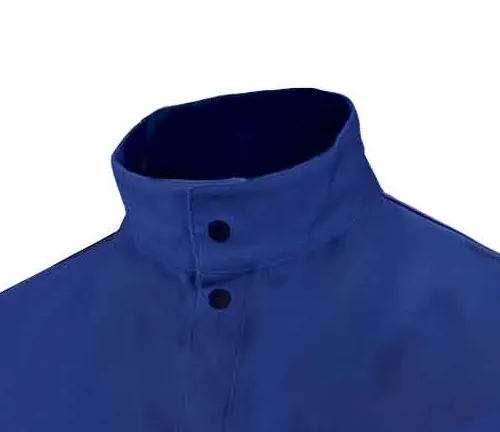 Close-up of the high collar of a blue welding coat with snap buttons.