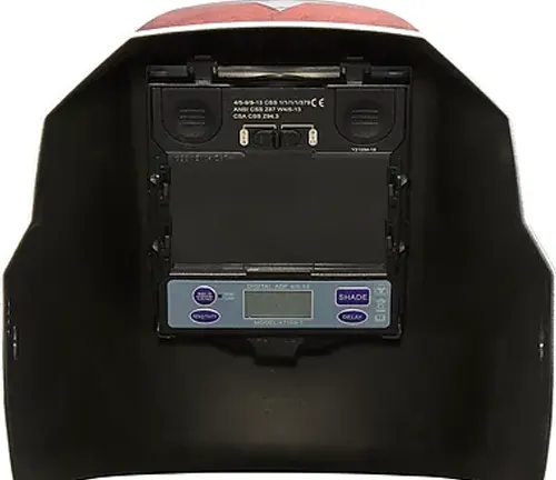 Inside view of a Jackson Safety auto-darkening welding helmet showing the control panel and lens.