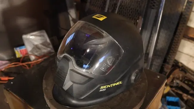 ESAB Sentinel A50 welding helmet displayed in a workshop environment.