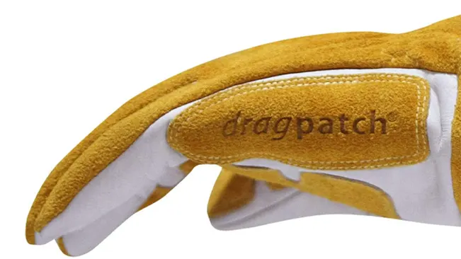 Detail of a Revco GM1611 welding glove with 'dragpatch' and yellow-white leather.