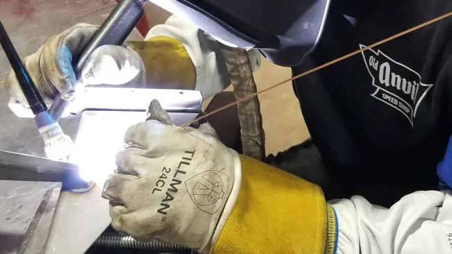 Welder using Tillman 24C Premium Kidskin TIG welding gloves to perform welding tasks.