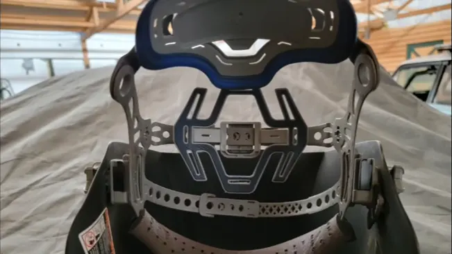 Interior view of a Miller Digital Infinity welding helmet focusing on the headgear and control panel.