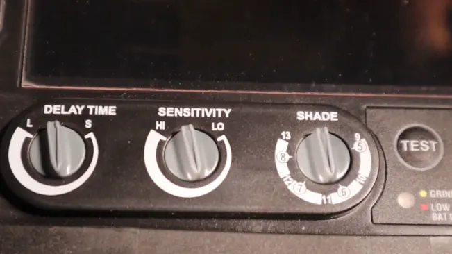 Close-up of the control knobs for delay time, sensitivity, and shade on a Lincoln Electric Viking 3350 welding helmet.





