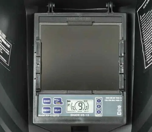 Close-up view of a Weldcote Metals Ultraview welding helmet's digital control panel and lens.