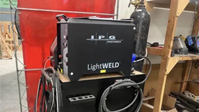 IPG LightWELD 1500 Handheld Laser Welder unit mounted on a cart in a workshop setting.