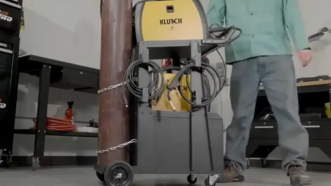 Klutch 2-Tier Welding Cart with gas cylinder and equipment, in use in a workshop setting.