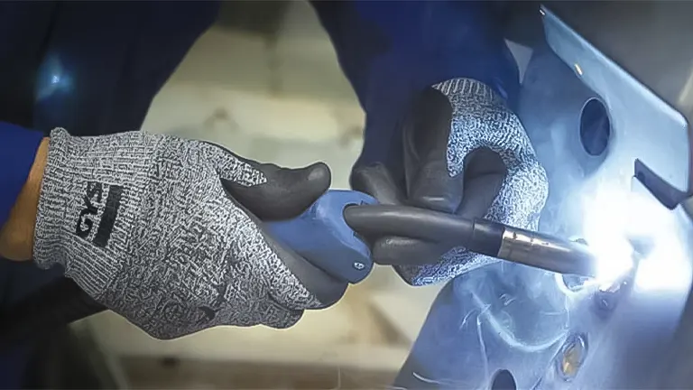 Person welding with protective gloves on