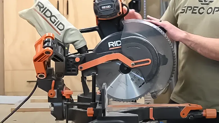 Person using a RIDGID miter saw in a workshop