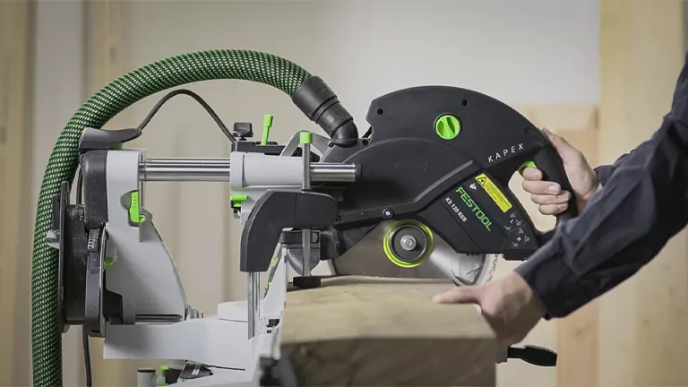 Modern green and black KAPEX miter saw with adjustable settings, ready for precise wood cutting