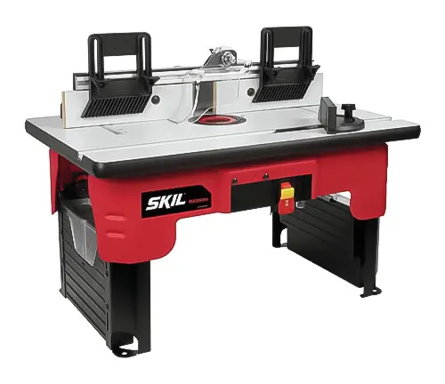 A SKIL RAS900 router table with a red and black base, featuring an aluminum fence and a red tabletop insert