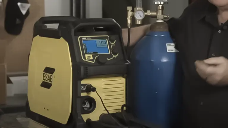 Person setting up an ESAB welder with a gas cylinder