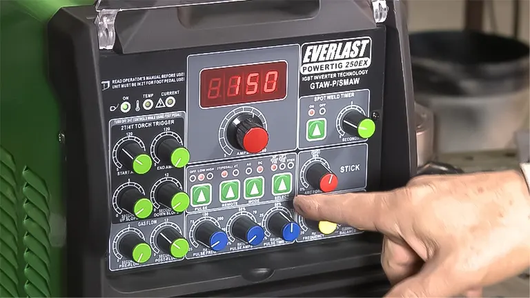 Person adjusting the controls on an Everlast PowerTIG 250EX welder