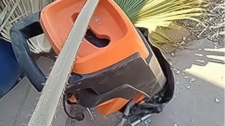 Orange and black wood chipper on chipped wood ground
