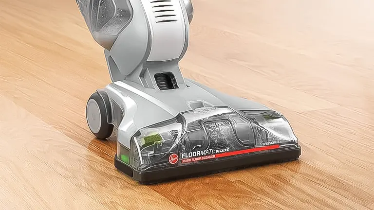Close-up of a Hoover FloorMate Deluxe hard floor cleaner's base on a wooden floor