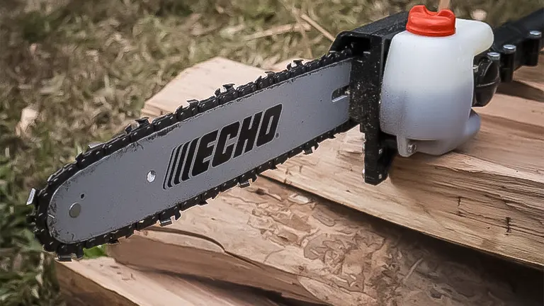 Close-up of the Echo X Series PPT-2620 pole saw chain and guide bar resting on wood