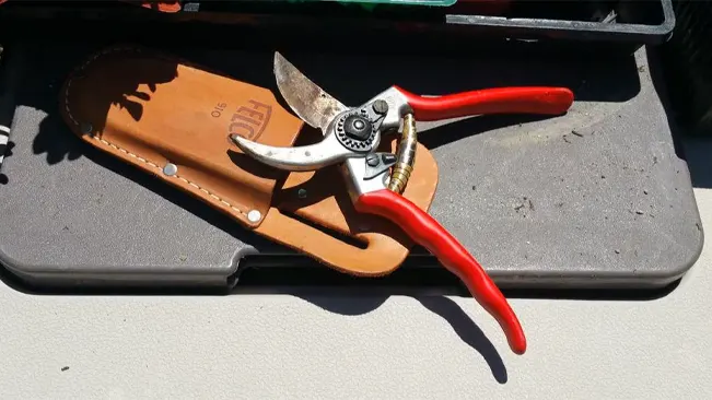 FELCO F2 Hand Pruners and leather sheath on a toolbox.