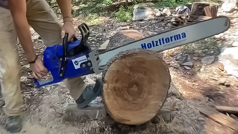 Individual using a Farmertec Holzfforma G660 Blue Thunder chainsaw on a large log outdoors