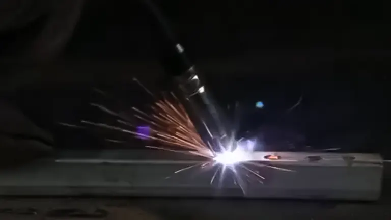 Welding process in action with sparks flying from the contact point