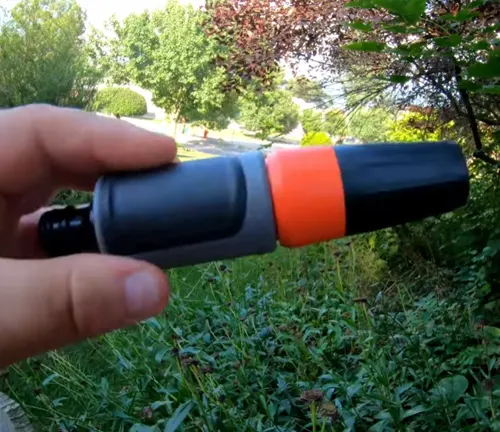 Person holding orange spray nozzle