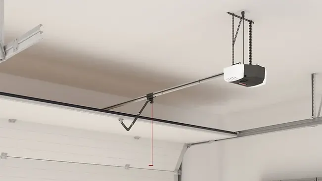 Automatic garage door opener mounted on a ceiling with the door closed