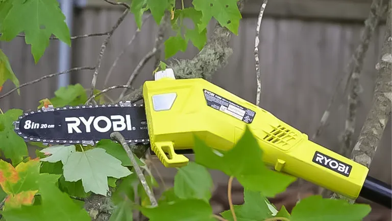 Close-up of a RYOBI ONE+ 18V 8-inch cordless pole saw cutting through branches