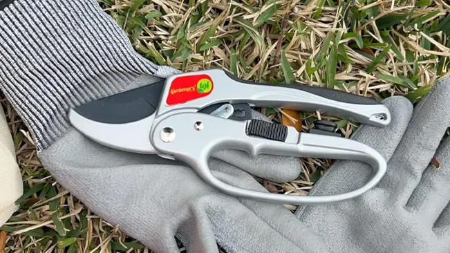 Ratchet pruning shears by The Gardener's Friend on gloves and grass.