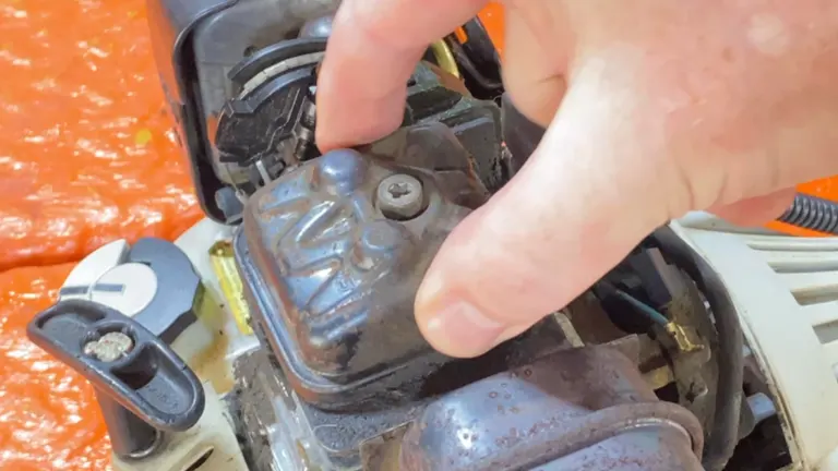 Person touching the valve cover of the weed eater