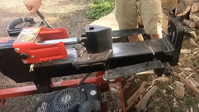 Side view of a Troy-Bilt 27-ton gas log splitter with a focus on the splitting mechanism and wheel