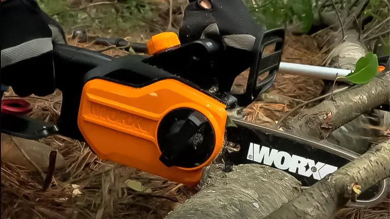 Close-up of Worx WG309 electric pole saw cutting a branch