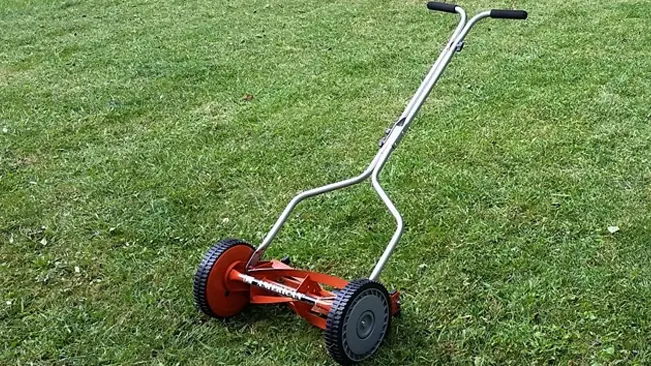Red lawn mower on grass