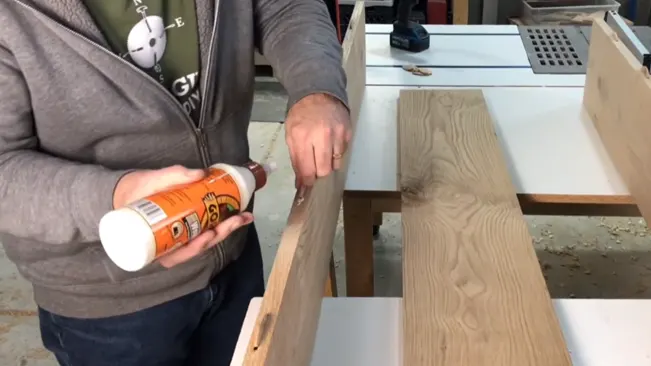 Person Putting a Glue in wooden plank