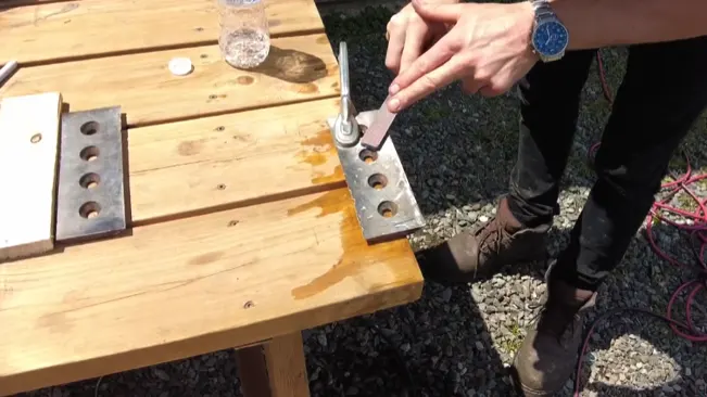 Man cleaning metal on table