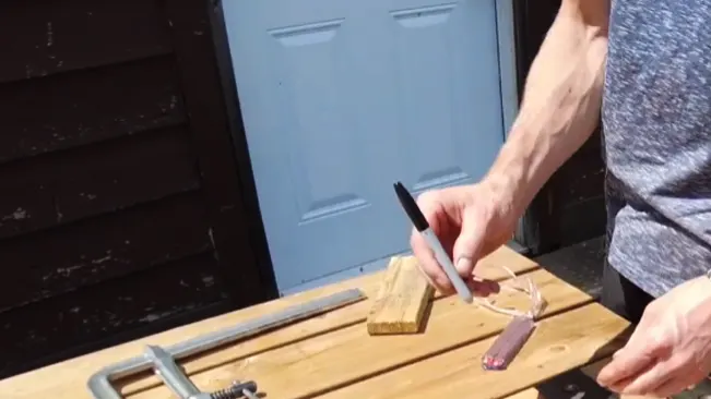 Person marking wood for a DIY project with tools nearby