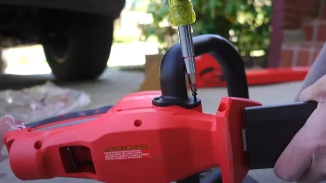 Person repairing hedge trimmer