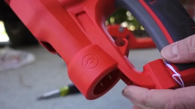 Close-up of red hedge trimmer handle