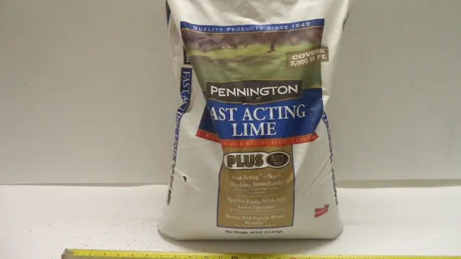 Bag of Pennington Fast Acting Lime on a shelf.