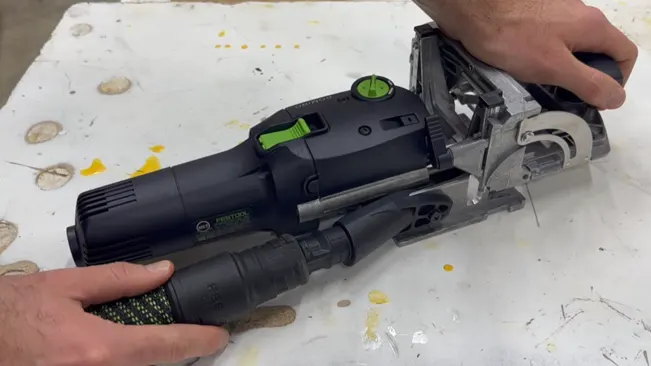 Person holding a Domino joiner power tool