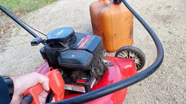 Person filling lawn mower with gas