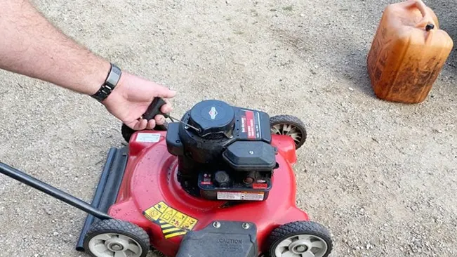 Lawn Mower a person pulling the cord to start