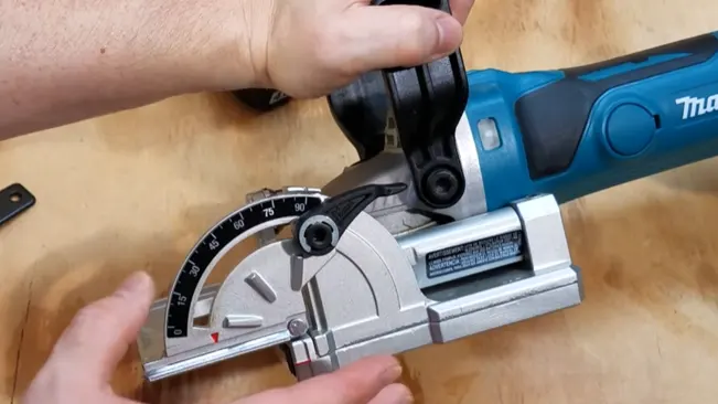 Person adjusting the cutting angle on a Makita biscuit joners