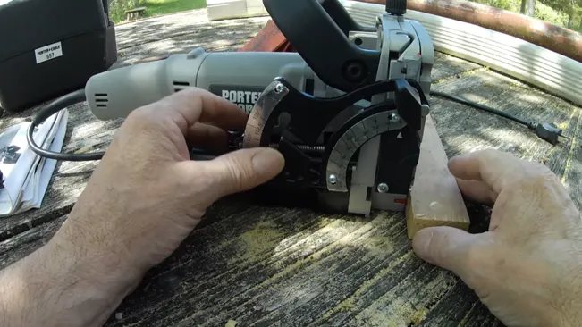 Person setting up a Porter-Cable biscuit joiner on wood