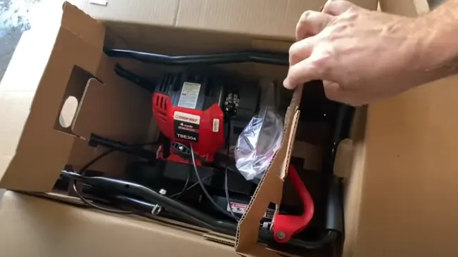 Person unpacking lawn mower
