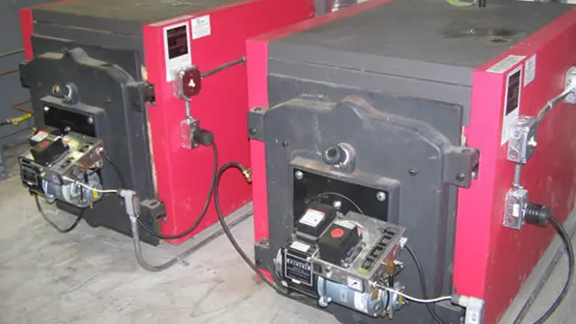 Two red and black wood boilers