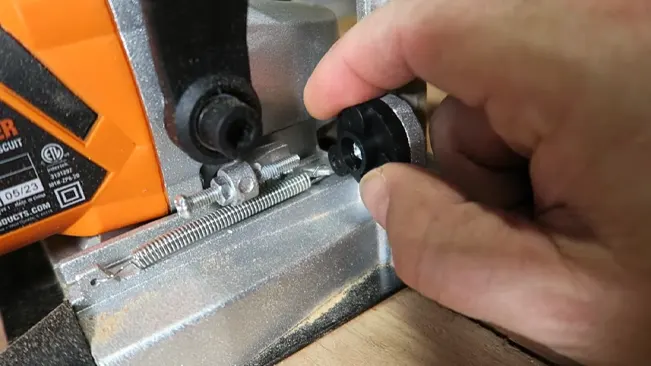 Hand adjusting knob on power tool.