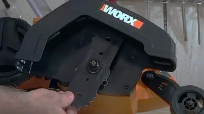 Person adjusting the blade of a WORX brand power tool